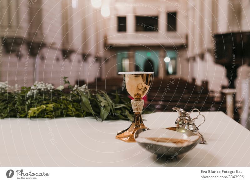goblet of wine on table during a wedding ceremony nuptial mass. Religion concept. Catholic eucharist ornaments for the celebration of the Eucharist Open Holy