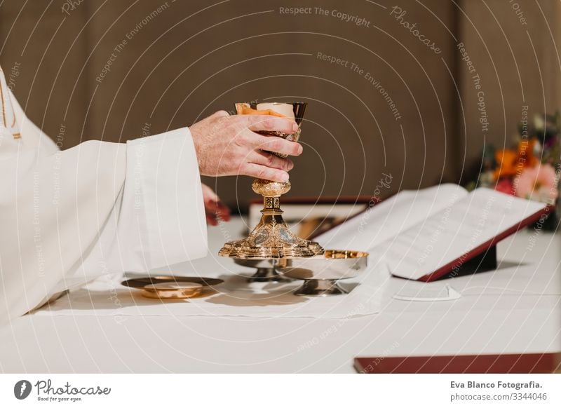 unrecognizable Priest holding the goblet during a wedding ceremony nuptial mass. Religion concept jesus Ritual Protestant Modern divine Cup eucharist Goblet