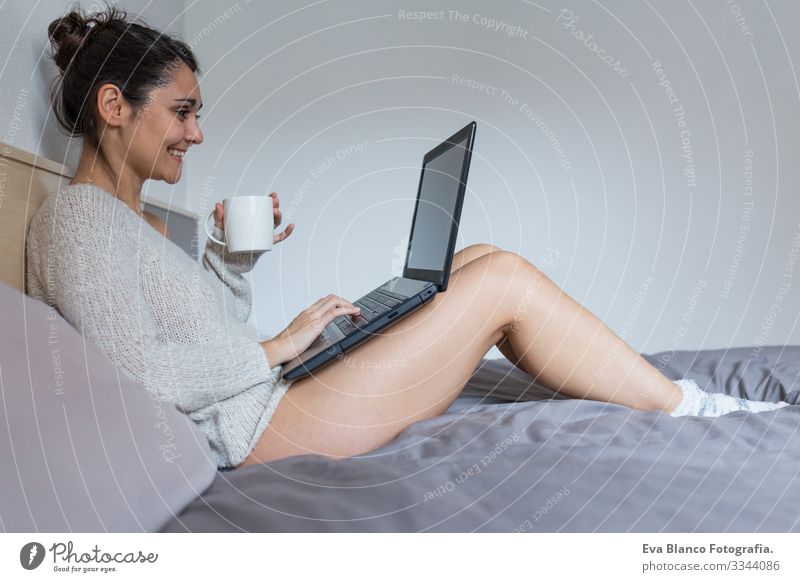 young woman having coffee and working on laptop Notebook Youth (Young adults) Woman Coffee Lifestyle Computer Cup Easygoing Internet Business Interlaced