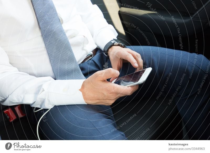 Close up of businessman using mobile smart phone in a car. Reading Decoration Work and employment Business Telephone PDA Screen Technology Internet Human being