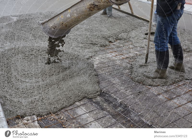 workers pouring wet concrete using concrete bucket. Work and employment Construction site Industry Business Building Street Concrete Steel Wet cement mix