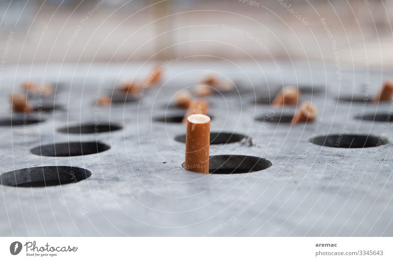 Cigarette ends in a waste bin Smoking Yellow Gray Cigarette Butt Dispose of Ashtray Trash container Colour photo Exterior shot Copy Space top Copy Space bottom