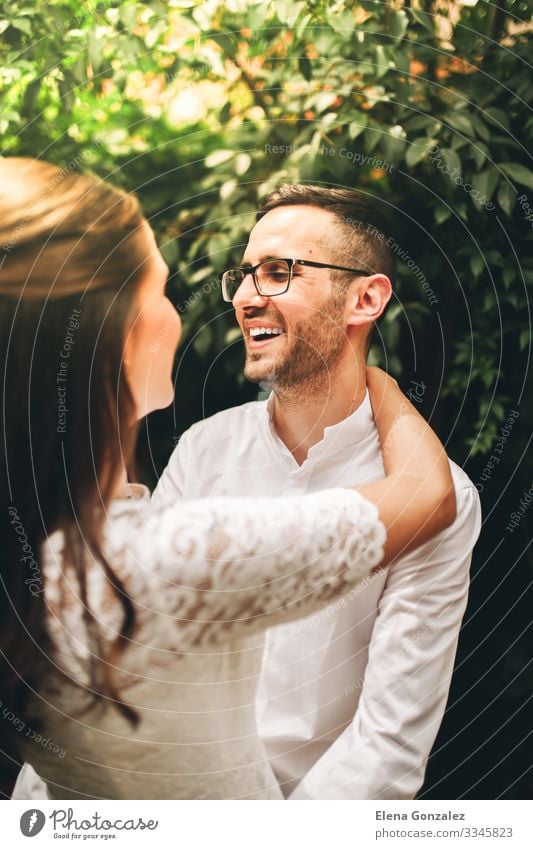 Newlywed couple looking at each other and smiling. Garden Feasts & Celebrations Wedding Woman Adults Man Kissing Love Embrace Emotions Romance Eternity