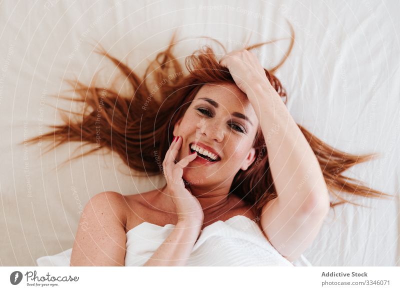 Smiling redheaded woman wearing lingerie lying on bed - a Royalty Free  Stock Photo from Photocase