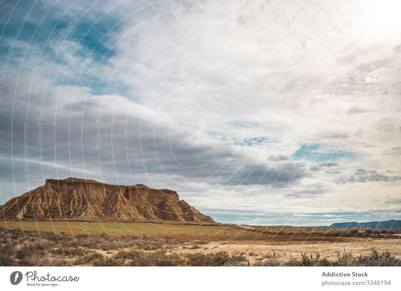 Tranquil landscape of empty valley and mountain desert shrub blue sky cloud scenic bardenas reales navarre spain nature sun summer rural trip travel countryside