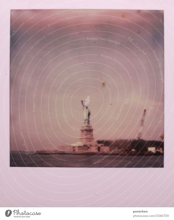 Polaroid shows Statue of Liberty in water in front of cloudy sky New York City USA Town Capital city Landmark Monument Statue of liberty Freedom Sky trump Water