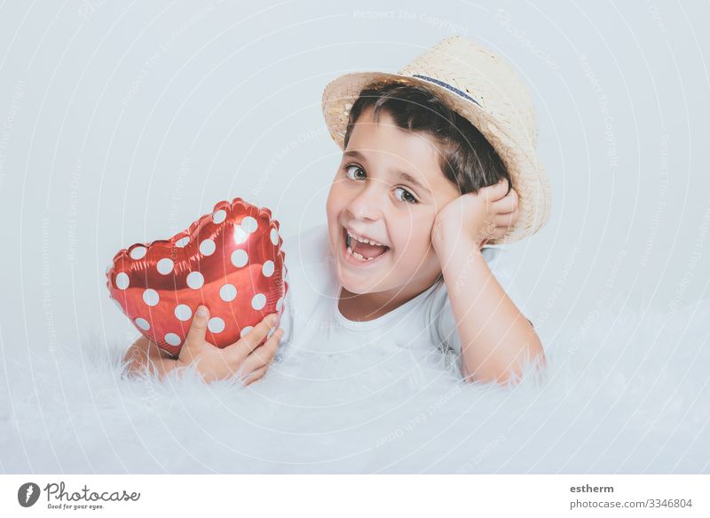 Smiling child with a heart-shaped balloont on white background Lifestyle Joy Health care Medication Feasts & Celebrations Valentine's Day Mother's Day