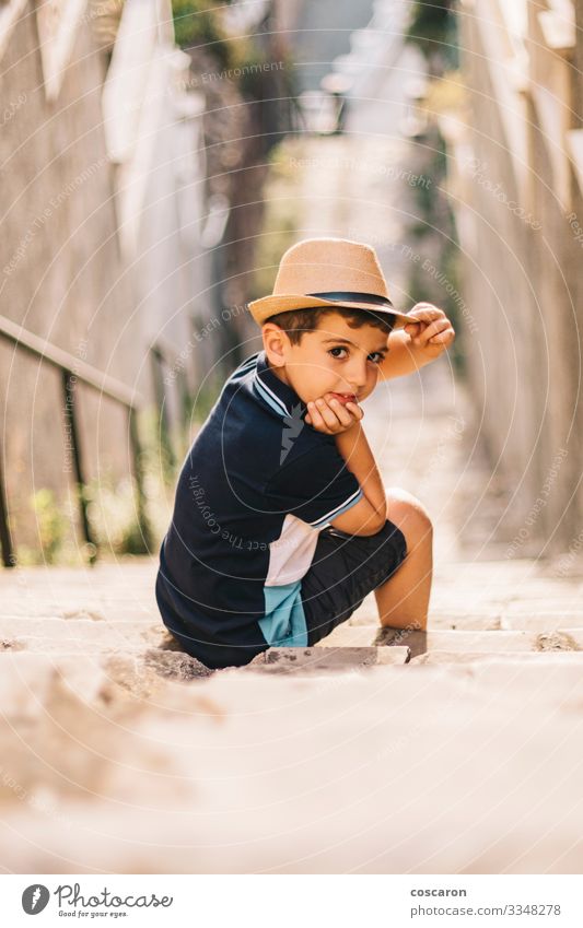 Portrait of a cute boy with hat on a stairs Lifestyle Style Joy Happy Beautiful Summer Summer vacation Sun Child Camera Human being Toddler Boy (child) Infancy