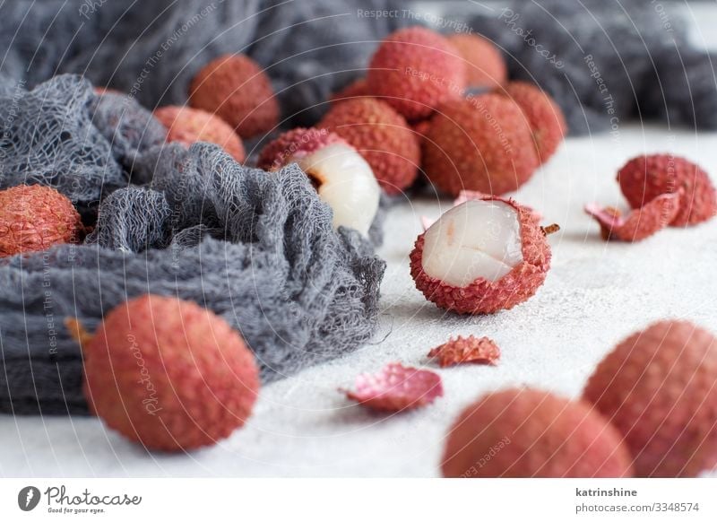 Fresh litchi fruits on a white table Fruit Diet Exotic Juicy Gray Pink White Lychee litchi fruits fruit Raw Open chinese asian Tropical Fruit flesh sweet lichi