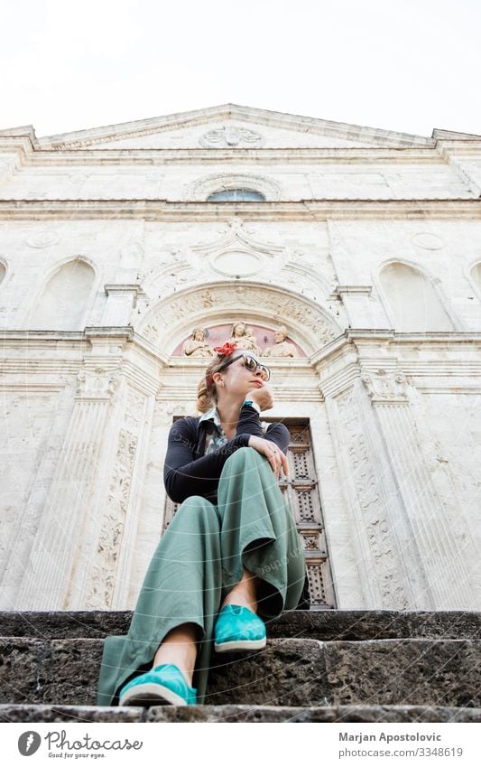 Young female traveler sitting on church steps in old town in Tuscany, Italy Lifestyle Vacation & Travel Tourism Trip Sightseeing City trip Human being Feminine