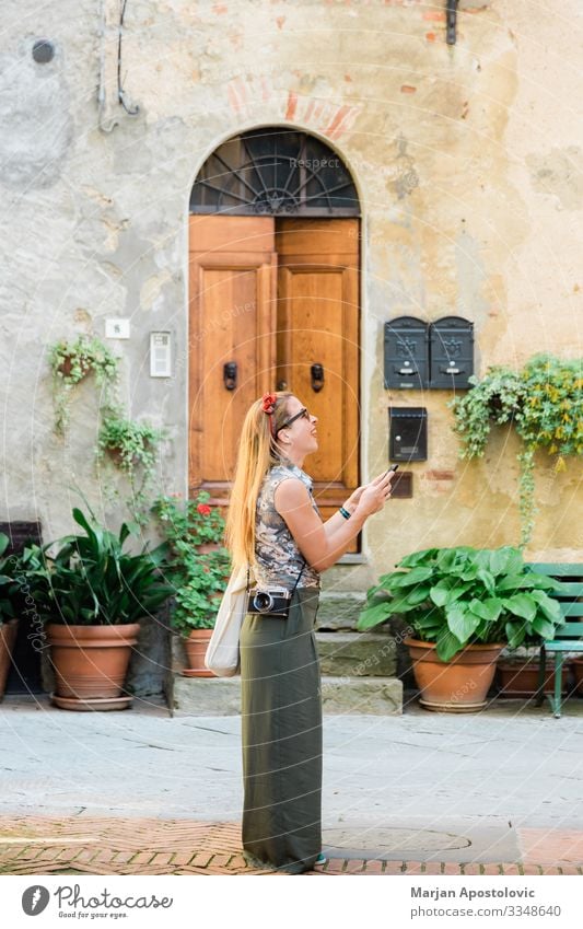 Young woman in an old town in Italy Lifestyle Joy Vacation & Travel Tourism Trip Sightseeing City trip Cellphone Camera Human being Feminine