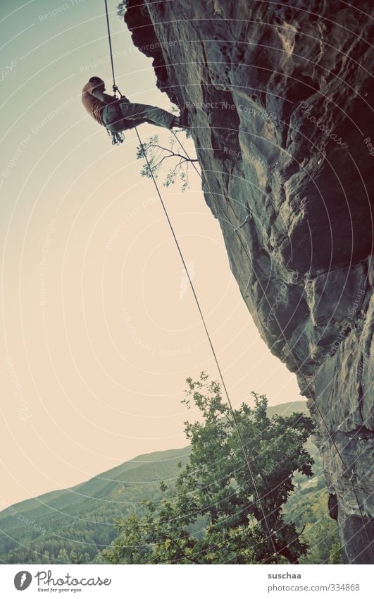 Dizzy, high. Landscape Nature Rock Mountain Climbing Mountaineer Human being Man Rope Dangerous Sports Tree Sky