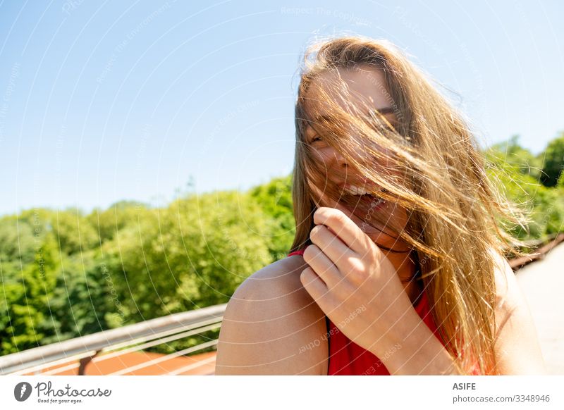 Portrait of a funny young woman enjoying the sun in a park Lifestyle Joy Happy Beautiful Face Relaxation Leisure and hobbies Summer Sun Woman Adults