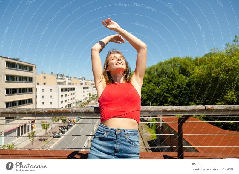 Young beautiful woman sunbathing on a bridge over the city Lifestyle Joy Happy Beautiful Relaxation Leisure and hobbies Summer Sun Woman Adults