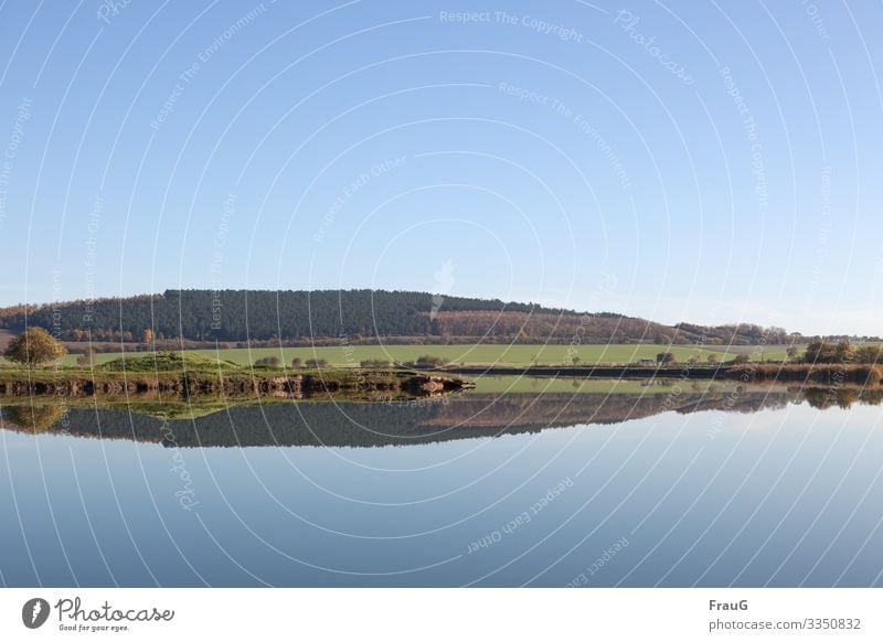 mirrored landscape Landscape Nature Lake Lakeside Calm Reflection Idyll Forest trees bank bushes Autumn Autumnal colours tranquillity Peaceful Sky