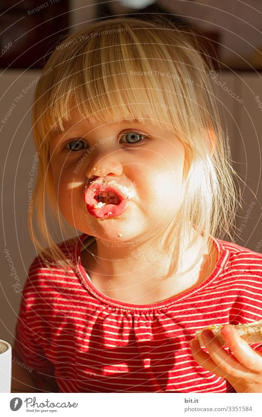 First the butter, then the bread, explains the little girl to the sunshine, with a smudged mouth. Children's game Kindergarten kita Parenting upbringing Sweet
