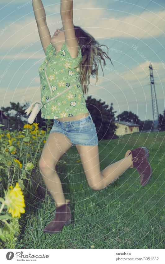 catch a ball with a flash of lightning Child Girl Exterior shot Summer Dusk Landscape Sunflower field Electricity pylon House (Residential Structure) Hop Jump