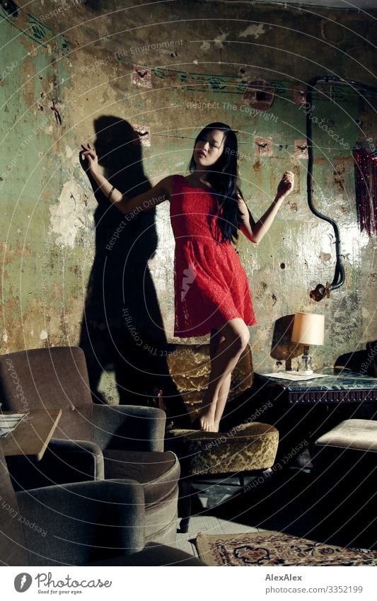 Portrait of a young woman in red dress on an armchair Style Joy Beautiful Life Armchair Living room Young woman Youth (Young adults) 18 - 30 years Adults Dress