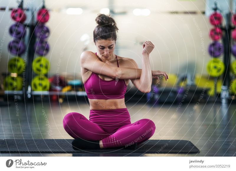 Young woman Doing Stretching Exercises on a yoga mat - a Royalty Free Stock  Photo from Photocase