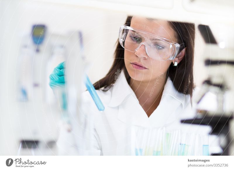 Scientists researching in scientific laboratory. Young female young PhD student scientist researching in the life science research laboratory. Health care