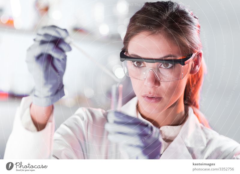 Young scientist pipetting in life science laboratory. Health care Medication Science & Research Laboratory Examinations and Tests Work and employment Doctor