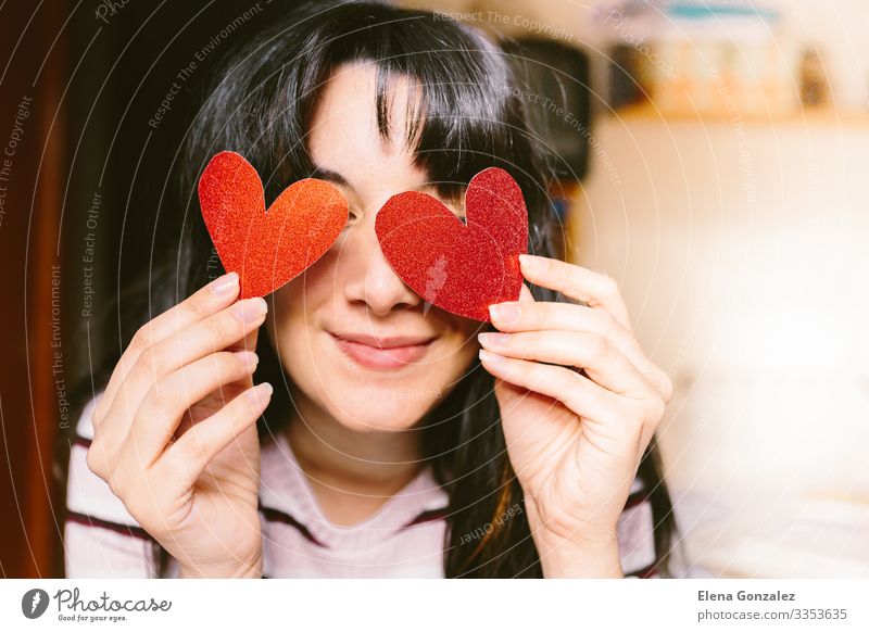 woman with red heart shaped cardboard in her eyes smiling. Happy Flirt Valentine's Day Office work Feminine Woman Adults Youth (Young adults) Lips Heart Smiling