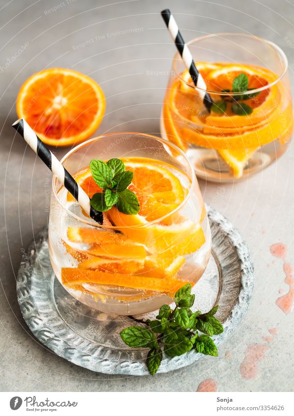 Summer drink with fresh oranges in a glass Fruit Herbs and spices Mint Orange Beverage Cold drink Drinking water Lemonade Alcoholic drinks Longdrink Cocktail