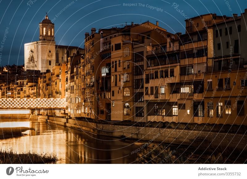 River reflecting city light flowing along buildings in evening church architecture reflection river illumination travel tourism houses girona catalonia spain