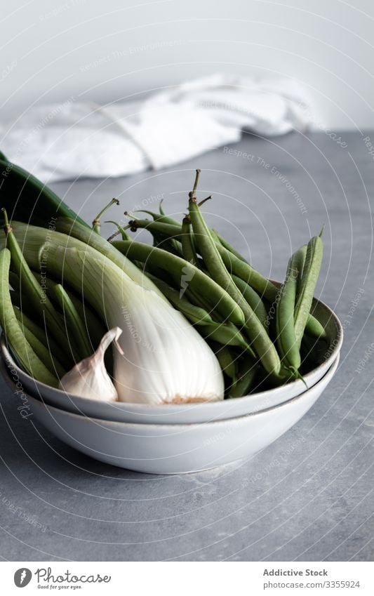Green onion and garlic with green beans in bowl green onion vegetable food healthy ingredient nutrition cuisine diet raw organic fresh rustic kitchen vitamin
