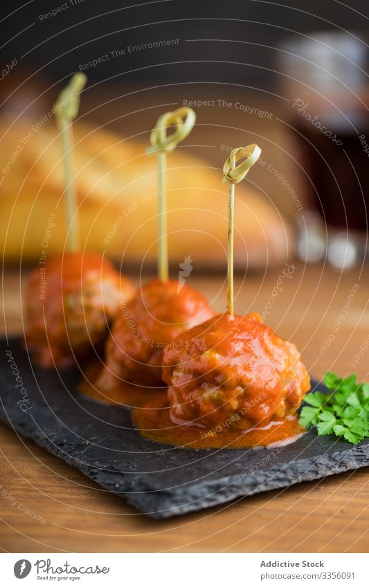 Delicious meat balls with tomato sauce on board meatball delicious bonded bamboo sticks food meal homemade gourmet dinner lunch cuisine dish recipe minced