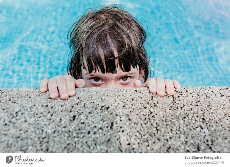 portrait of a beautiful kid girl in a pool. Smiling. Fun and summer lifestyle Action Swimming pool Beauty Photography Exterior shot Youth (Young adults)