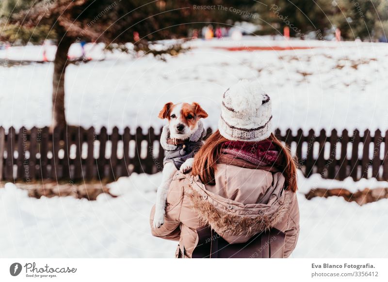 woman holding on shoulder her cute jack russell dog. Winter season at the mountain Playing Snow ball Woman Dog Mountain Exterior shot Vacation & Travel