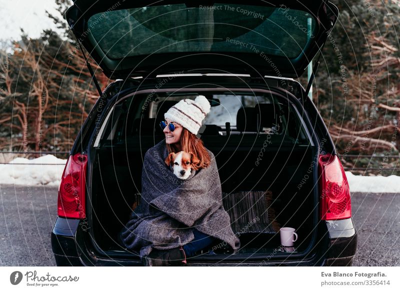 woman and cute jack russell dog enjoying outdoors at the mountain into the car. Travel concept. winter season Woman Dog Car Snow Mountain Exterior shot