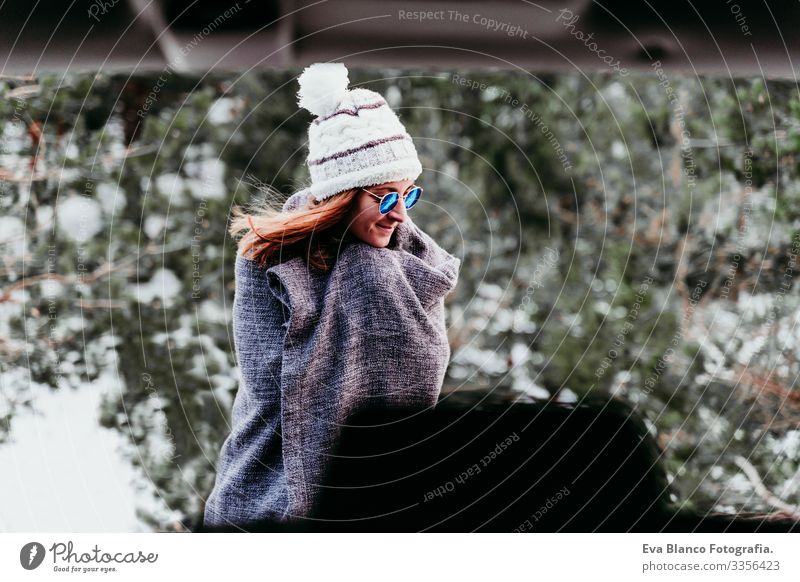 portrait outdoors at the mountain of young woman wearing winter clothes Portrait photograph Woman Snow Forest Hat Blanket Modern Relaxation Nature To enjoy