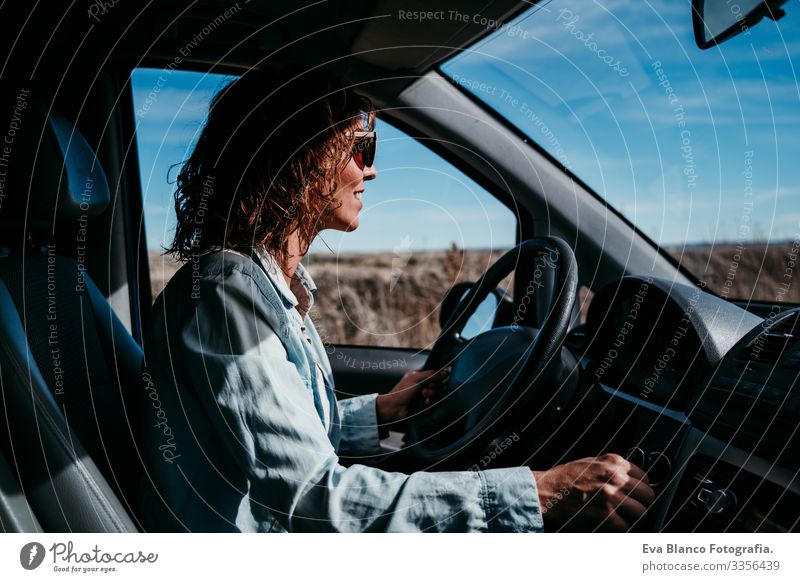 young beautiful woman driving a car. travel concept Woman Youth (Young adults) Driving Car Sunbeam Sunglasses Vacation & Travel Traveling Wheel Drive hire Share