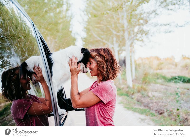 woman hugging her border collie dog in a van. Travel concept Woman Dog Van van life Vacation & Travel Traveling owner Youth (Young adults) Modern Autumn Spring