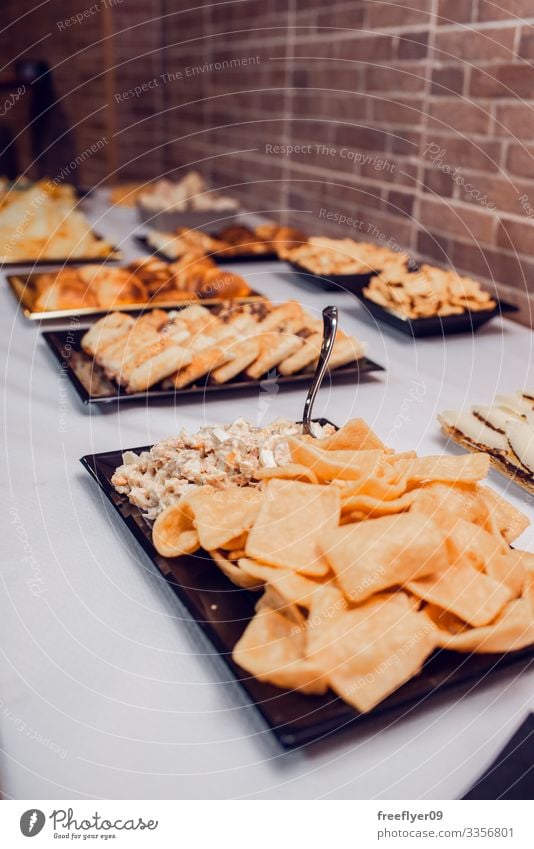 Table of snacks for a party lunch white counter table buffet holiday appetizer decoration food line service anniversary banquet dining eat dish desert cater