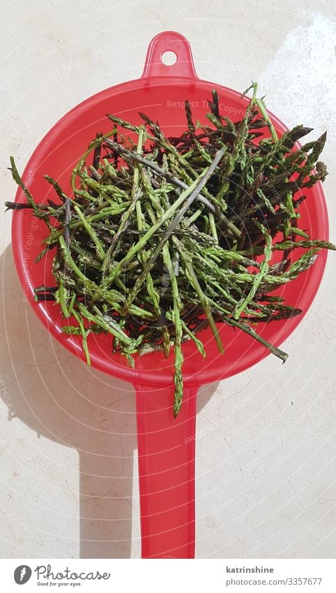 Wiild asparagus in a red colander on a stone background Nutrition Diet Sieve Stone Fresh Natural Wild Green Red Asparagus wild asparagus mediterranean adriatic