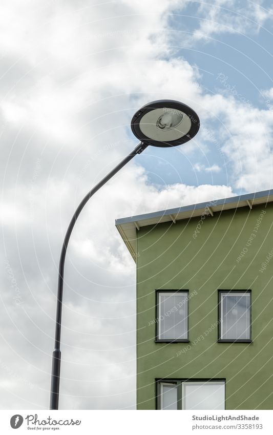 Streetlamp and facade of a green house Lifestyle House (Residential Structure) Lamp Environment Sky Clouds Town Building Architecture Facade Simple Modern New