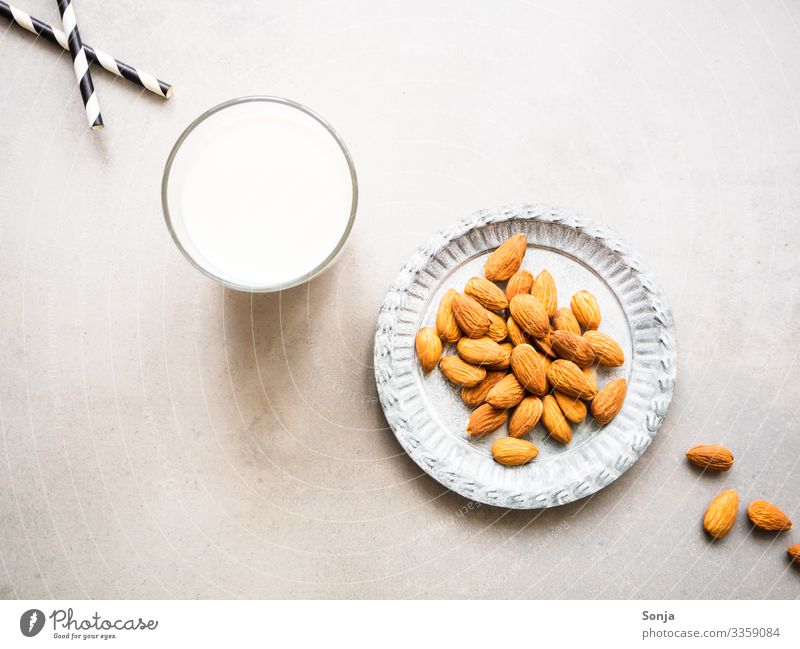 A glass of almond milk and a plate of almonds Food Dairy Products Almond Nutrition Breakfast Organic produce Vegetarian diet Diet Beverage Milk Plate Glass