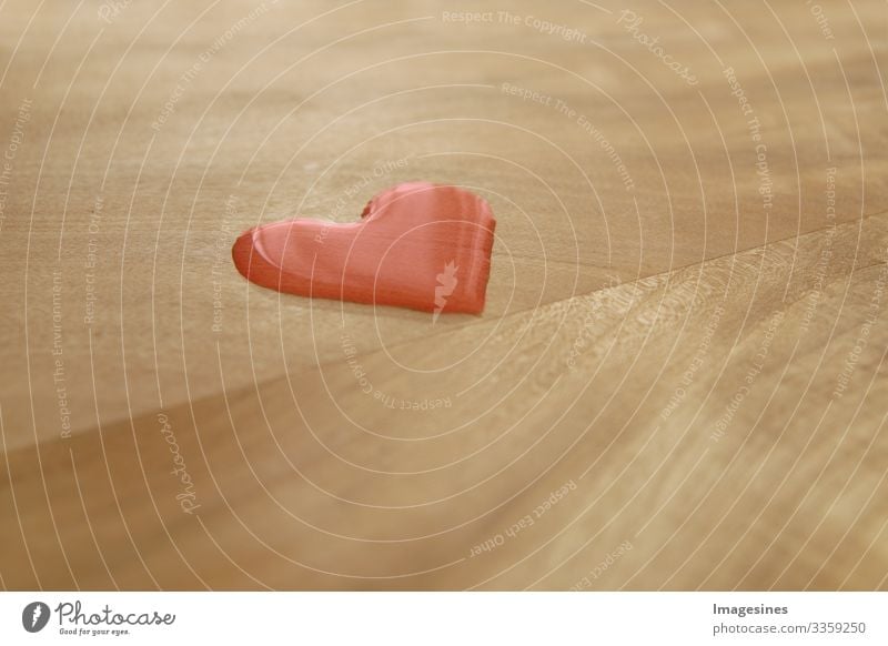 Heart Disease - heart drop, red water drop in the shape of a heart on a wooden table, Valentine's Day concept. Heart-shaped water drops. Nature symbol for love, happiness, health
