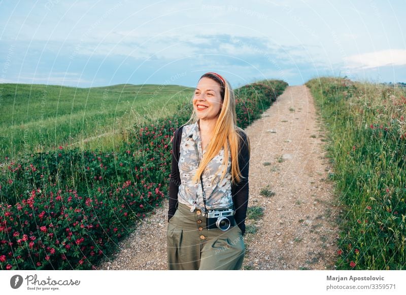 Young woman walking in countryside in Tuscany, Italy Lifestyle Vacation & Travel Tourism Trip Adventure Camera Human being Feminine Youth (Young adults) Woman