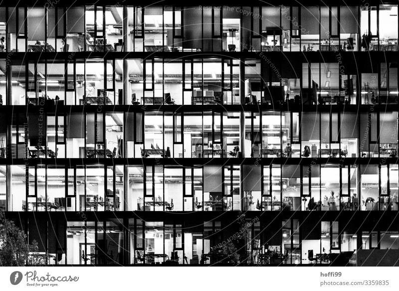 illuminated offices of a high-rise building in the evening - closing time High-rise Office work Closing time Illuminated Bank building Facade Capital city