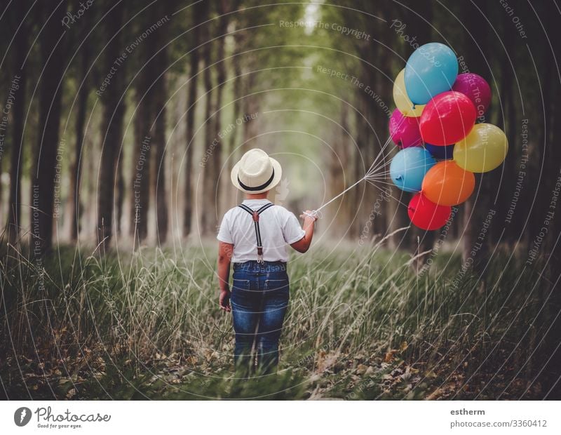 Back view of thoughtful child with balloons in the in the forest outdoor Lifestyle Relaxation Vacation & Travel Freedom Summer Human being Masculine Child
