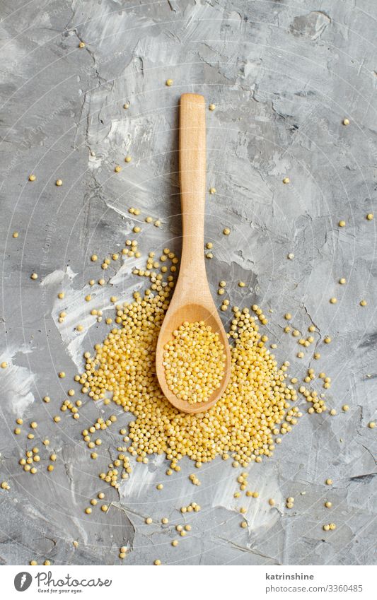 Raw dry hulled millet with a spoon Vegetarian diet Diet Spoon Natural Above Yellow Gray Millet negative space Copy Space Dried fiber food healthy Ingredients