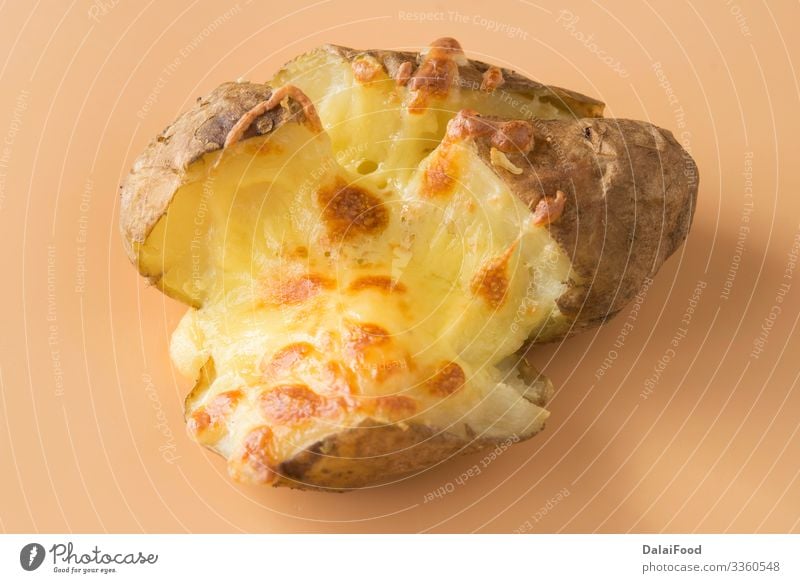 Jacket potatoes with cheddar cheese Cheese Diet England food Baking Cooking brown background Potatoes shredded Colour photo