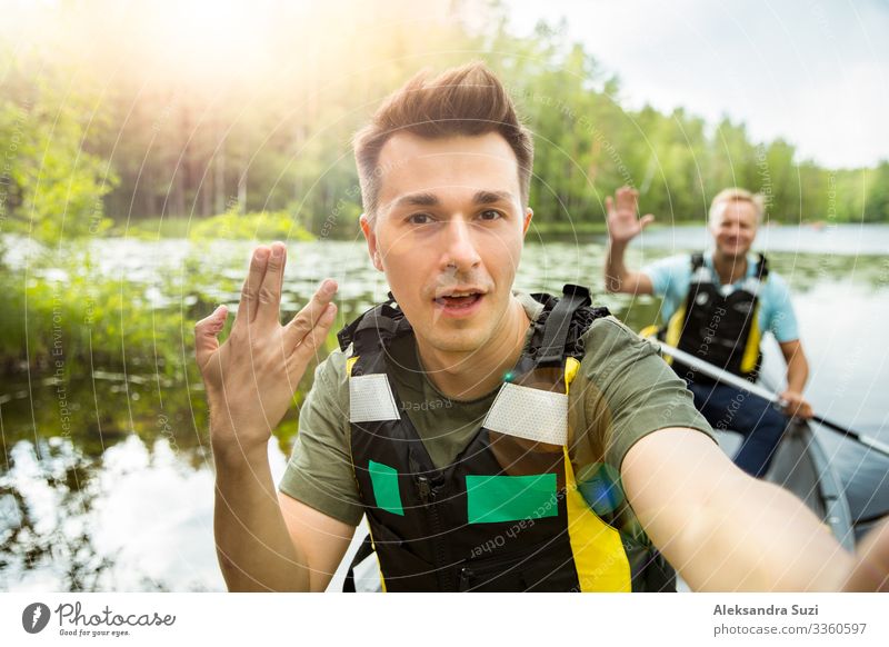 Two men in life vests canoeing in forest lake. Action Adventure Canoe Destination Discover Finland Forest Happy Vacation & Travel Lifestyle Man Nature