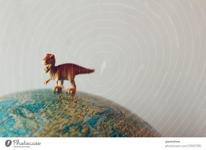 Dinosaur figure T-Rex on globe Climate change Wild animal 1 Animal Aggression Old Extinct Meteor Globe Earth Figure Toys Threat Carnivore Colour photo