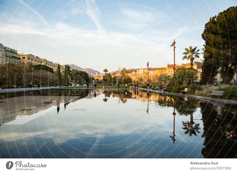 Nice, France - 20.03.2018: fountains of Promenade du Paillon, reflections on water surface, sunset. Architecture Building City editorial Europe Fountain French