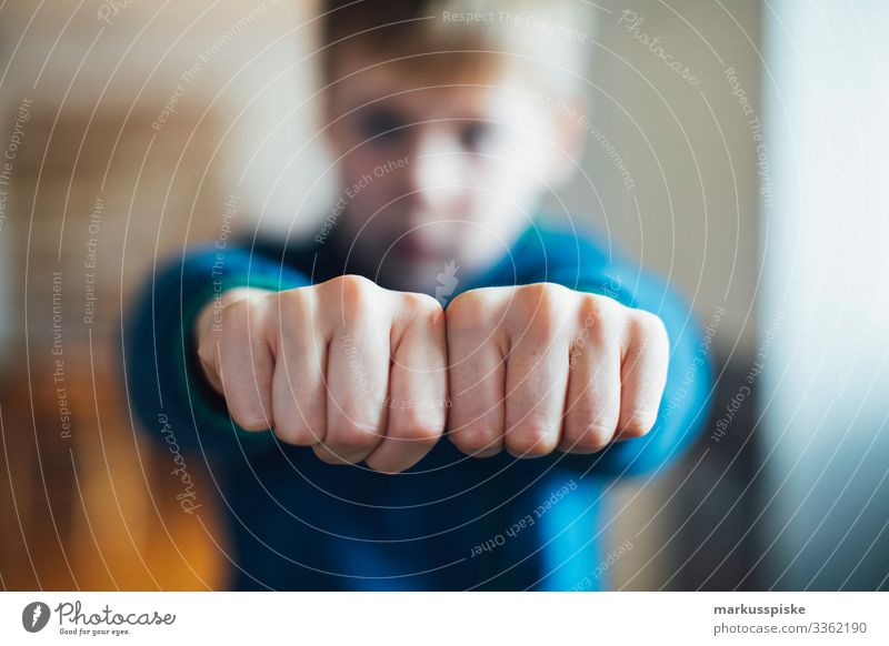 Boy shows clenched fists Boy (child) Infancy Children's game Fingers hands Symbols and metaphors symbolic power Symbolism Aggression aggressively Fist